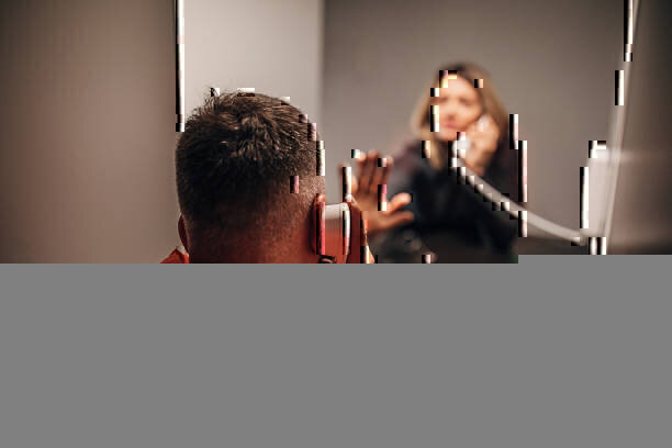 Sad young woman and her husband sitting in prison visiting room
